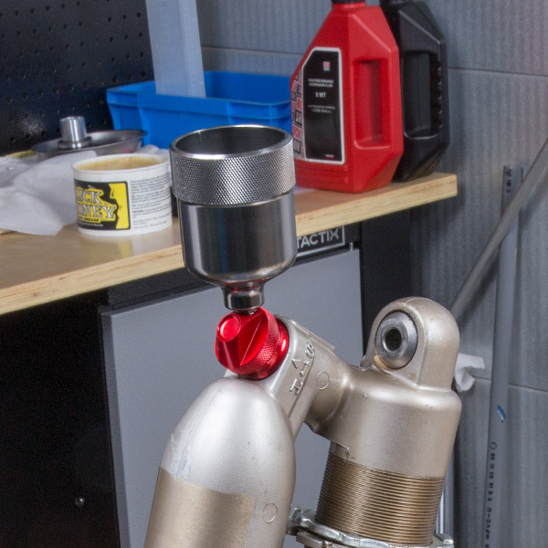 Air bleed cup for KYB SHOWA and WP rear suspensions.